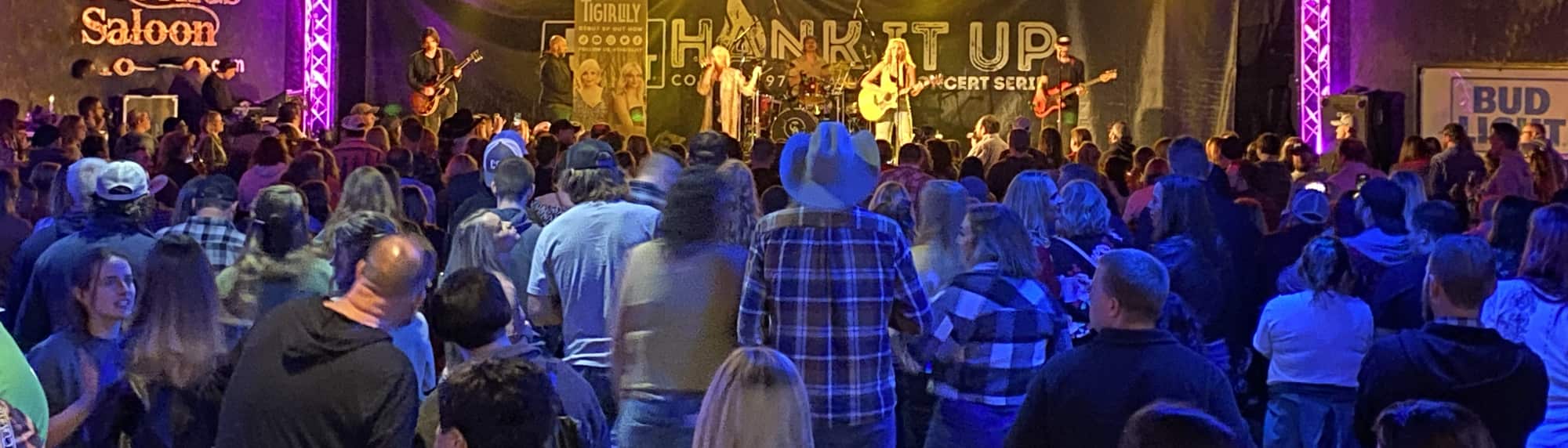 country concert with fans wearing cowboy hats East Lansing