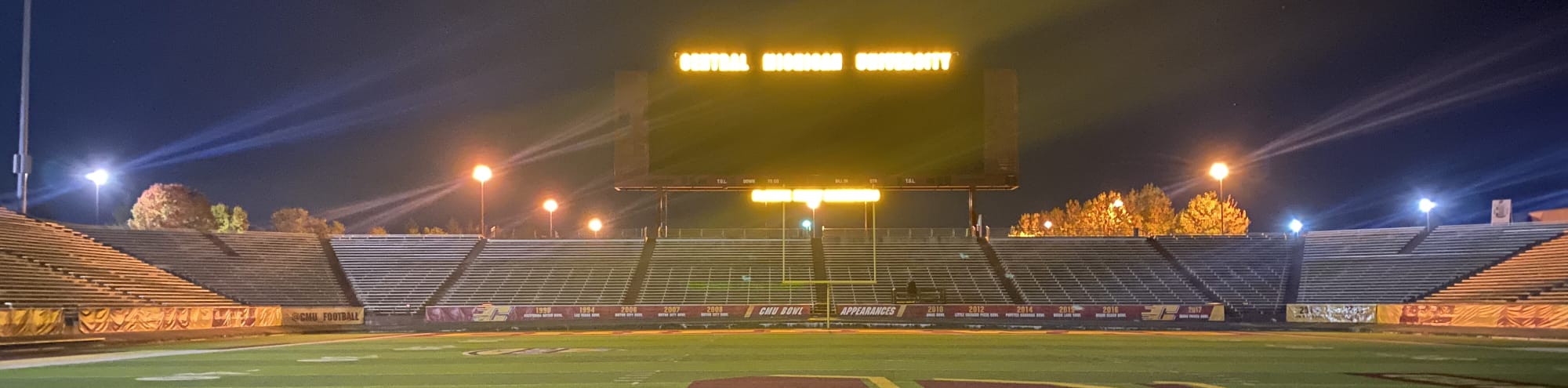 empty football stadium at night under the lights East Lansing
